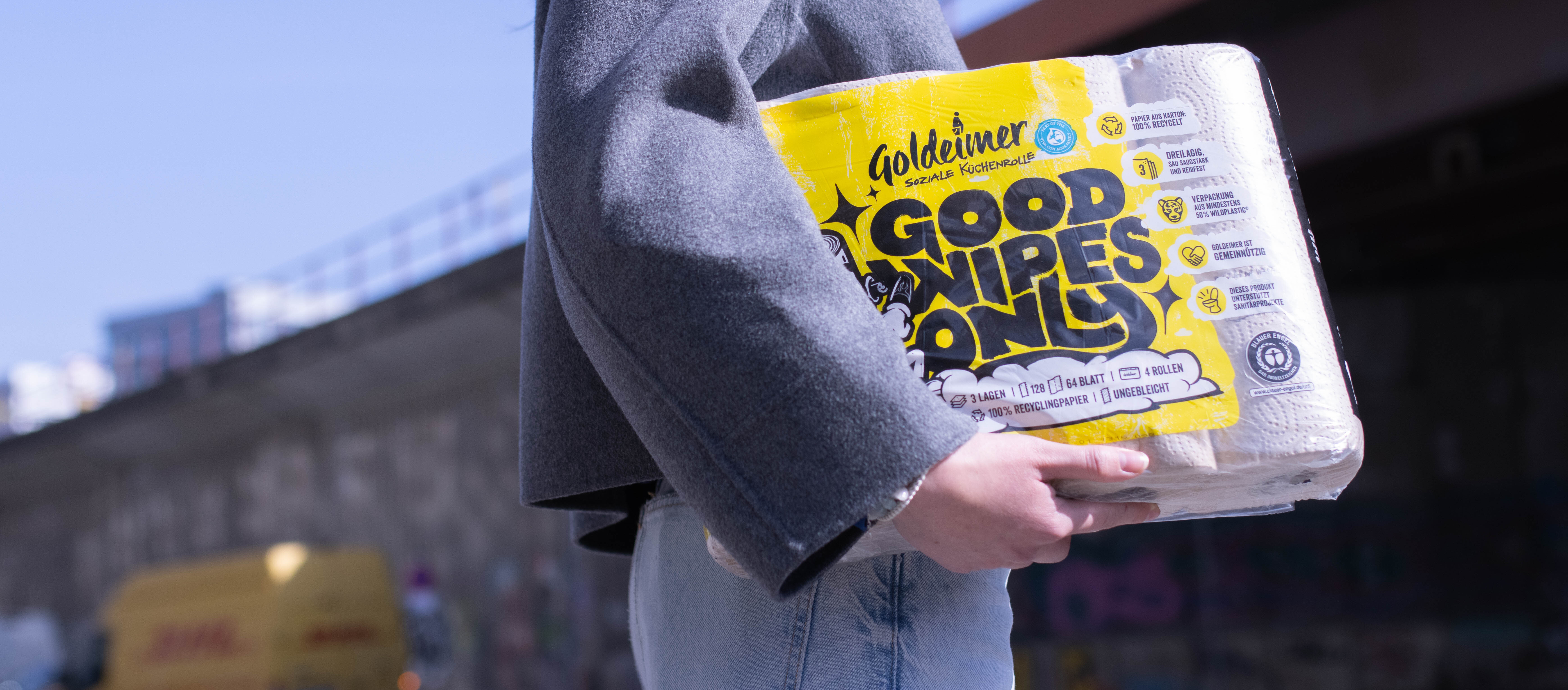 Eine Person hält eine Schachtel mit Tüchern.
